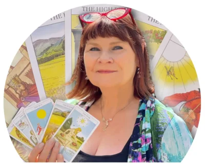 Photo of Tarot Card Reader and trainer Suzanne Lane holding Tarot Cards